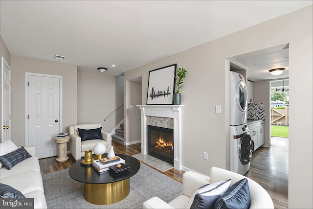 2801 Banks Ct, Dumfries, VA 22026 - living area with estacked washer and dryer, wood finished floors, stairway, and a premium fireplace