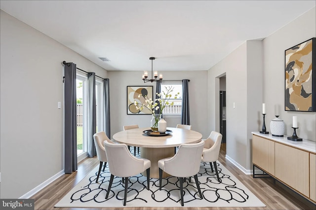 2801 Banks Ct, Dumfries, VA 22026 - dining area with a chandelier, healthy amount of natural light, and light wood-style floors