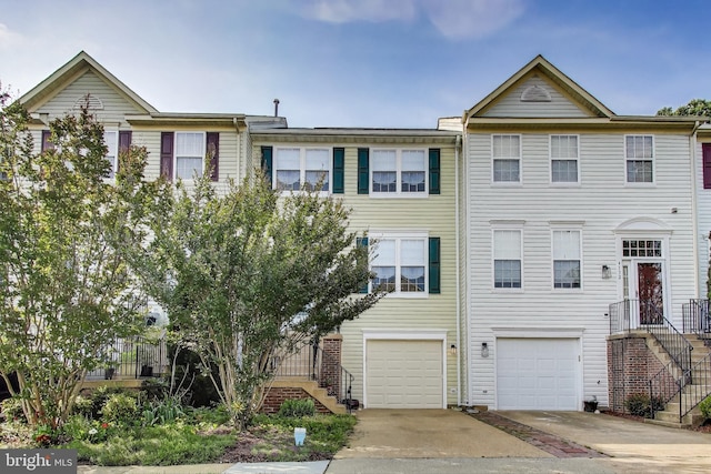 4174 La Mauricie Loop, Dumfries, VA 22025 - view of property with driveway, an attached garage, and stairway