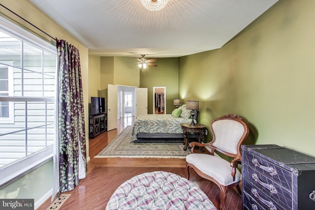 4174 La Mauricie Loop, Dumfries, VA 22025 - bedroom featuring wood finished floors, a walk in closet, and a ceiling fan