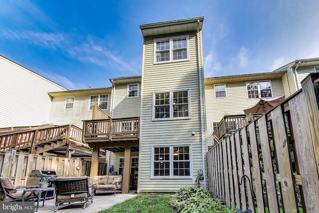 4174 La Mauricie Loop, Dumfries, VA 22025 - back of property featuring a wooden deck, an outdoor living space, and a patio