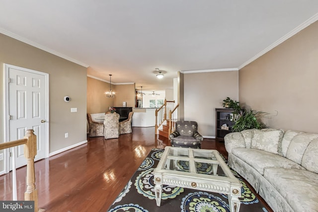 4174 La Mauricie Loop, Dumfries, VA 22025 - living room featuring a chandelier, wood finished floors, crown molding, and stairs