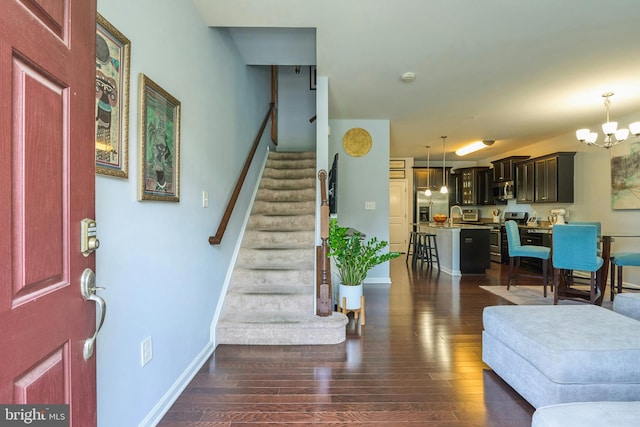 9423 Geaton Park Pl, Lanham, MD 20706 - foyer featuring stairway, dark wood-type flooring, and a chandelier