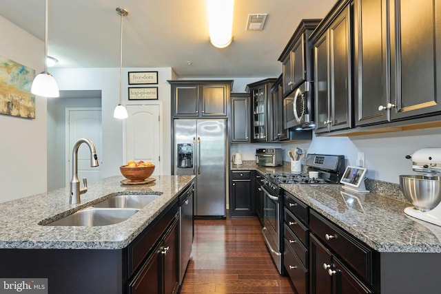 9423 Geaton Park Pl, Lanham, MD 20706 - kitchen with appliances with stainless steel finishes, dark wood-type flooring, glass insert cabinets, decorative light fixtures, and stone countertops