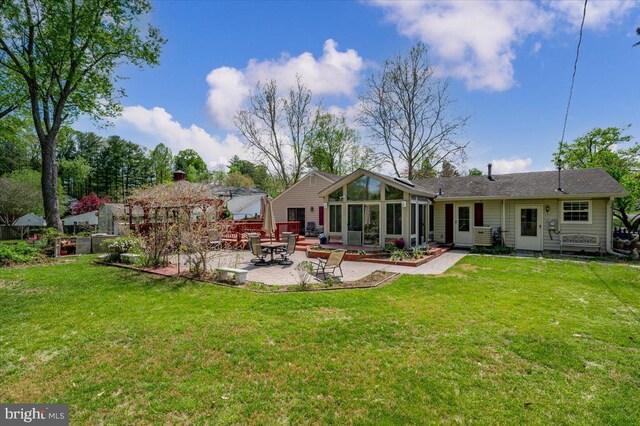 16102 Philmont Ln, Bowie, MD 20716 - back of property featuring a patio, a sunroom, and a yard