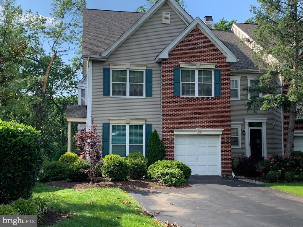 108 Lemonton Way, Wayne, PA 19087 - view of front facade featuring asphalt driveway, roof with shingles, a chimney, an attached garage, and brick siding