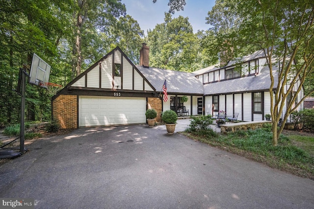 553 Choptank Cove Ct, Annapolis, MD 21401 - view of front of home with asphalt driveway, a garage, a chimney, and brick siding