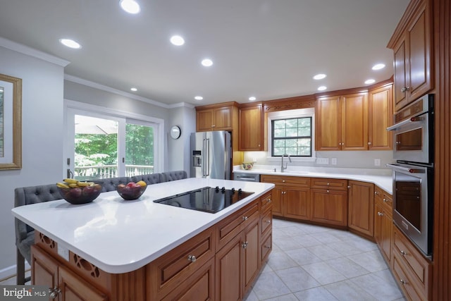553 Choptank Cove Ct, Annapolis, MD 21401 - kitchen with appliances with stainless steel finishes, crown molding, light countertops, brown cabinetry, and recessed lighting