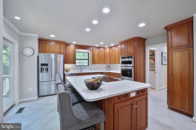553 Choptank Cove Ct, Annapolis, MD 21401 - kitchen with stainless steel appliances, light countertops, recessed lighting, ornamental molding, and a center island