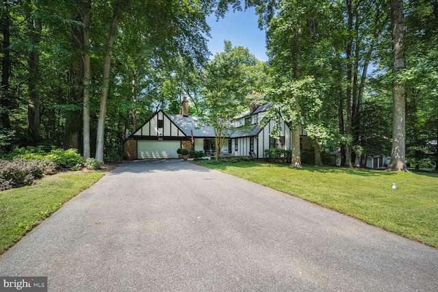 553 Choptank Cove Ct, Annapolis, MD 21401 - tudor-style house featuring driveway, a front lawn, a chimney, and an attached garage