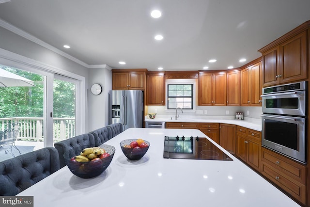 553 Choptank Cove Ct, Annapolis, MD 21401 - kitchen featuring appliances with stainless steel finishes, light countertops, ornamental molding, brown cabinetry, and recessed lighting