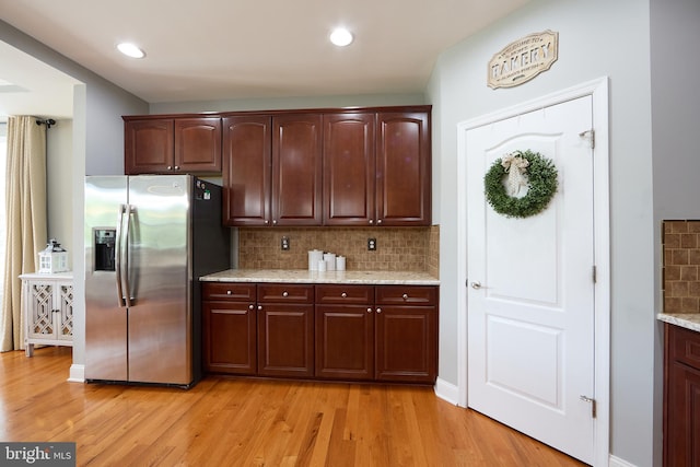 722 Cherry Tree Rd, Middletown, DE 19709 - kitchen with stainless steel fridge, light wood finished floors, tasteful backsplash, light stone counters, and recessed lighting