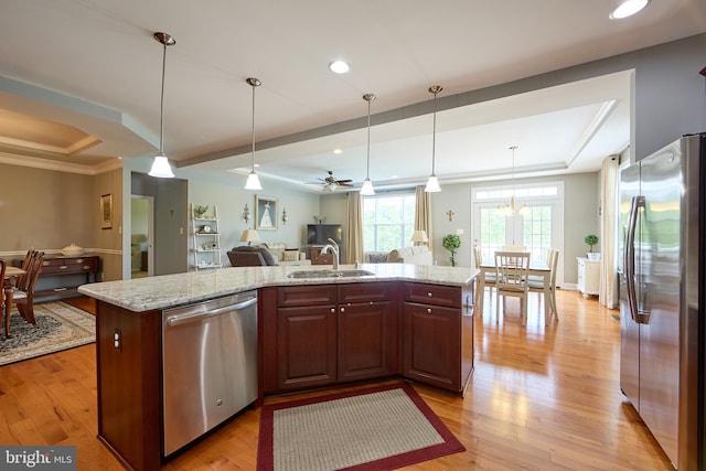 722 Cherry Tree Rd, Middletown, DE 19709 - kitchen featuring stainless steel appliances, a raised ceiling, open floor plan, ornamental molding, and light stone countertops