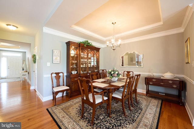 722 Cherry Tree Rd, Middletown, DE 19709 - dining area with a chandelier, a tray ceiling, light wood-type flooring, plenty of natural light, and ornamental molding
