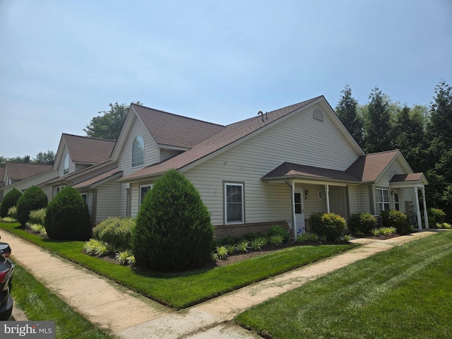2030 Rudy Serra Dr Unit D, Eldersburg, MD 21784 - view of side of property featuring a yard, brick siding, and roof with shingles
