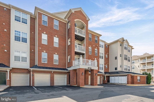 9713 Handerson Pl Unit 203, Manassas Park, VA 20111 - view of apartment building / complex with an attached garage and driveway
