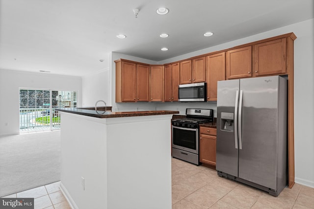 9713 Handerson Pl Unit 203, Manassas Park, VA 20111 - kitchen with appliances with stainless steel finishes, dark countertops, recessed lighting, light tile patterned floors, and brown cabinetry