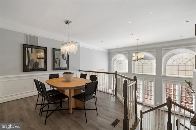 2517 Hunton Pl, Alexandria, VA 22311 - dining area with wood finished floors, a chandelier, and crown molding