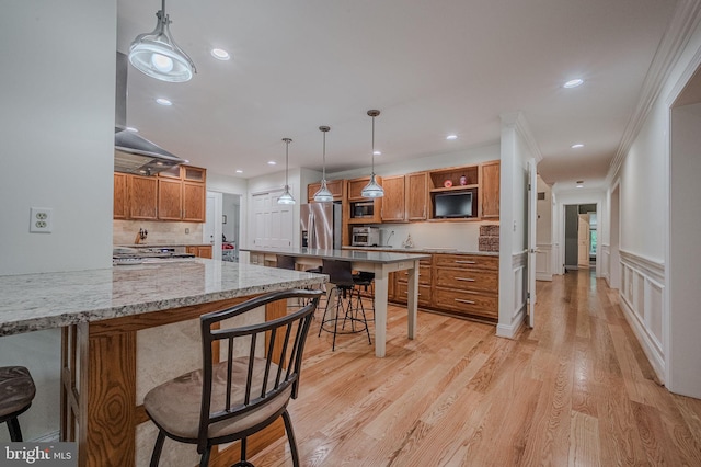 310 Belmont Ct, Lincoln University, PA 19352 - kitchen with appliances with stainless steel finishes, brown cabinets, a kitchen bar, light wood-style floors, and recessed lighting