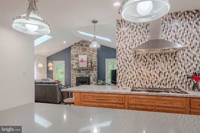 310 Belmont Ct, Lincoln University, PA 19352 - kitchen featuring stainless steel gas cooktop, a skylight, backsplash, vaulted ceiling, and a fireplace