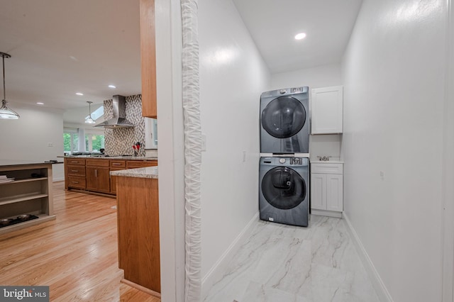 310 Belmont Ct, Lincoln University, PA 19352 - laundry room with stacked washer / dryer, recessed lighting, and light marble finish floors