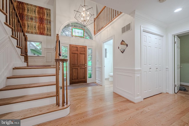 310 Belmont Ct, Lincoln University, PA 19352 - foyer featuring light wood-style floors, a decorative wall, stairs, a chandelier, and a towering ceiling