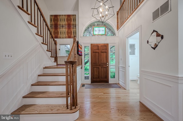 310 Belmont Ct, Lincoln University, PA 19352 - entrance foyer with a decorative wall, stairway, a chandelier, light wood-type flooring, and a high ceiling