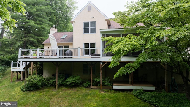 310 Belmont Ct, Lincoln University, PA 19352 - rear view of house with stucco siding, a wooden deck, a yard, a chimney, and roof with shingles