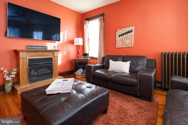 902 Station Ave, Haddon Heights, NJ 08035 - living area with radiator heating unit, hardwood / wood-style flooring, a glass covered fireplace, and a ceiling fan