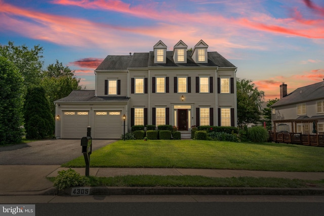 4305 Mulcaster Ter, Dumfries, VA 22025 - view of front facade with asphalt driveway, a front lawn, and an attached garage