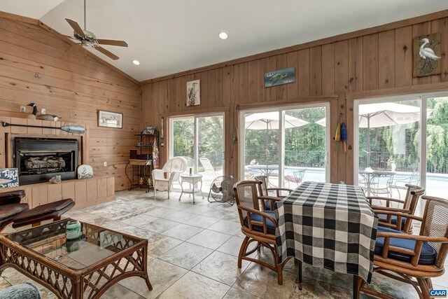 1505 Running Deer Dr, Keswick, VA 22947 - dining room featuring vaulted ceiling, wood walls, a ceiling fan, a sunroom, and light tile patterned floors