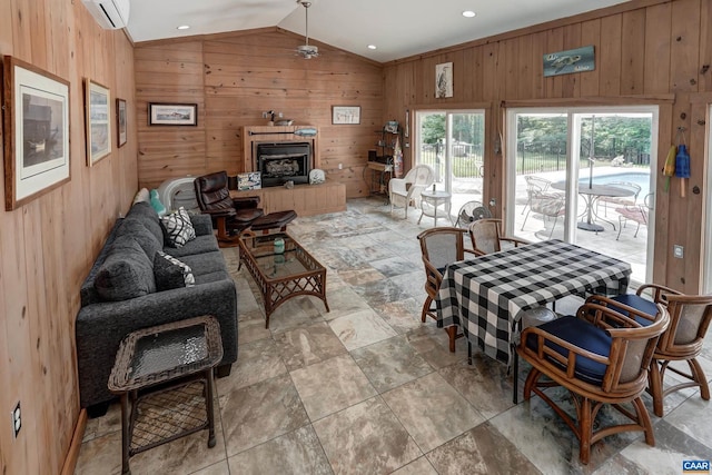 1505 Running Deer Dr, Keswick, VA 22947 - living area featuring vaulted ceiling, a wall mounted air conditioner, wooden walls, a ceiling fan, and a fireplace with raised hearth