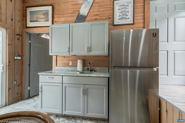 1505 Running Deer Dr, Keswick, VA 22947 - kitchen featuring freestanding refrigerator, wood walls, light stone counters, and gray cabinets