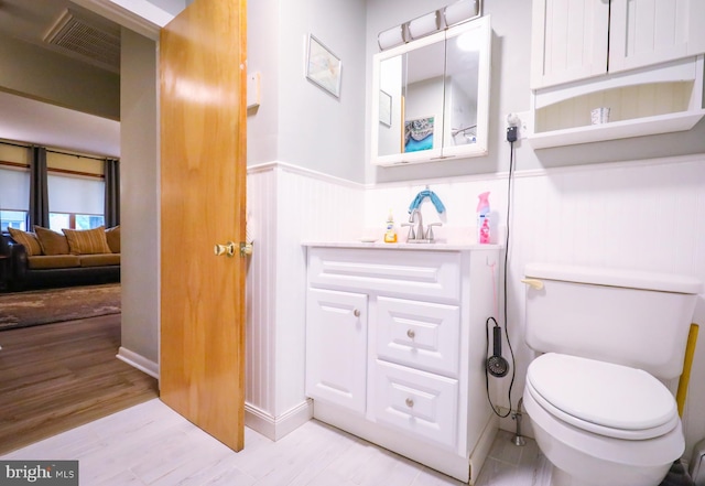 962 Bridge Rd, Collegeville, PA 19426 - bathroom with wainscoting, vanity, and wood finished floors