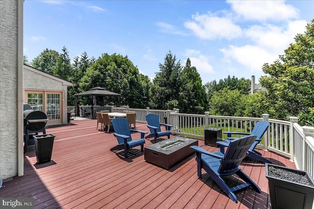 22 Thomas Speakman Dr Unit 76, Glen Mills, PA 19342 - deck with a fire pit, outdoor dining area, grilling area, a gazebo, and view of wooded area