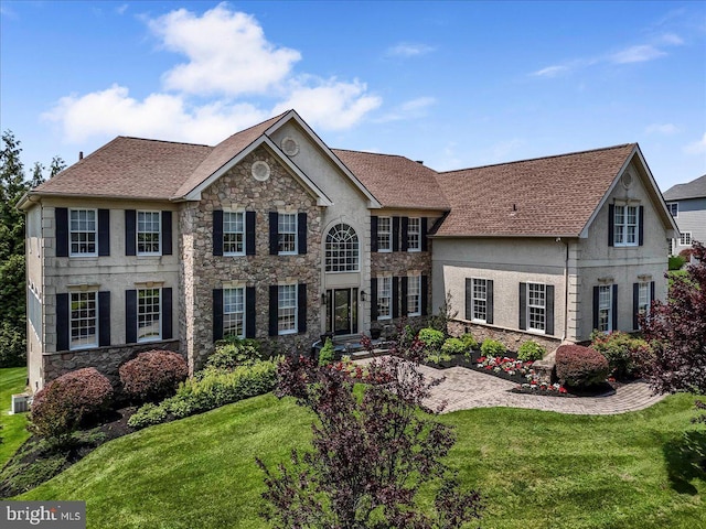 22 Thomas Speakman Dr Unit 76, Glen Mills, PA 19342 - colonial home with stone siding, stucco siding, a front yard, and a shingled roof