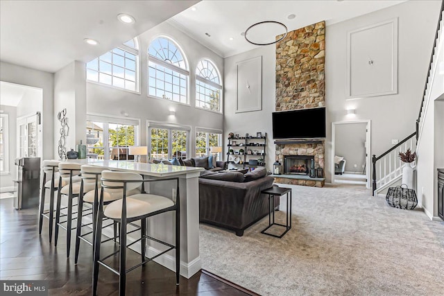 22 Thomas Speakman Dr Unit 76, Glen Mills, PA 19342 - living room featuring a fireplace, stairway, a towering ceiling, recessed lighting, and dark carpet