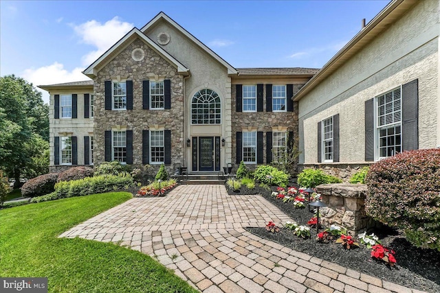 22 Thomas Speakman Dr Unit 76, Glen Mills, PA 19342 - view of front of home with stone siding, a front yard, and stucco siding