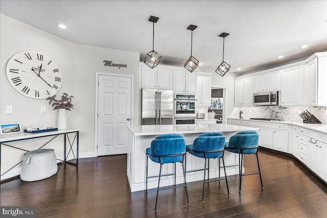 22 Thomas Speakman Dr Unit 76, Glen Mills, PA 19342 - kitchen with appliances with stainless steel finishes, backsplash, dark wood-style floors, a kitchen breakfast bar, and white cabinets