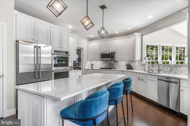 22 Thomas Speakman Dr Unit 76, Glen Mills, PA 19342 - kitchen with stainless steel appliances, a kitchen island, backsplash, white cabinets, and recessed lighting