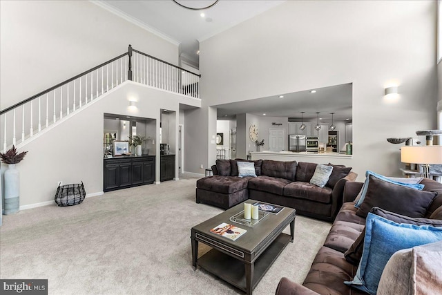 22 Thomas Speakman Dr Unit 76, Glen Mills, PA 19342 - living room featuring carpet flooring, a towering ceiling, crown molding, and stairs