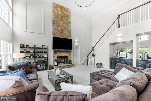 22 Thomas Speakman Dr Unit 76, Glen Mills, PA 19342 - carpeted living area featuring a high ceiling, plenty of natural light, a fireplace, and stairs
