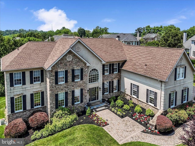 22 Thomas Speakman Dr Unit 76, Glen Mills, PA 19342 - colonial-style house featuring stone siding, a shingled roof, and stucco siding
