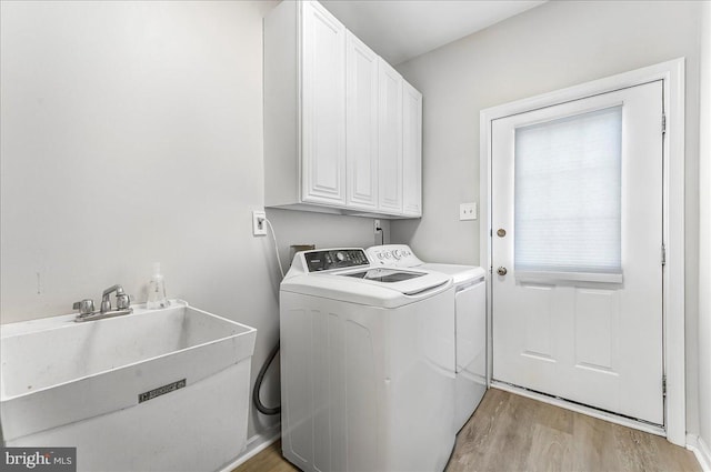 22 Thomas Speakman Dr Unit 76, Glen Mills, PA 19342 - washroom featuring cabinet space, light wood-style floors, and separate washer and dryer