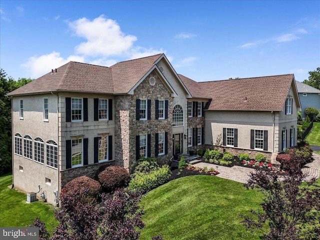 22 Thomas Speakman Dr Unit 76, Glen Mills, PA 19342 - colonial-style house featuring stone siding, a front lawn, and stucco siding