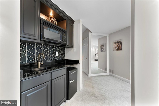22 Thomas Speakman Dr Unit 76, Glen Mills, PA 19342 - kitchen featuring black microwave, dark countertops, light colored carpet, backsplash, and gray cabinetry