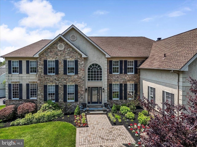 22 Thomas Speakman Dr Unit 76, Glen Mills, PA 19342 - colonial home featuring stucco siding, stone siding, and roof with shingles