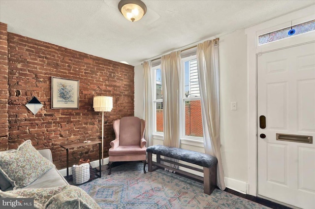 409 N Cherry St, Lancaster, PA 17602 - living area featuring brick wall and a textured ceiling