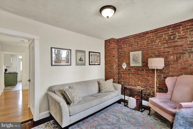 409 N Cherry St, Lancaster, PA 17602 - living room with brick wall, wood finished floors, and a textured ceiling