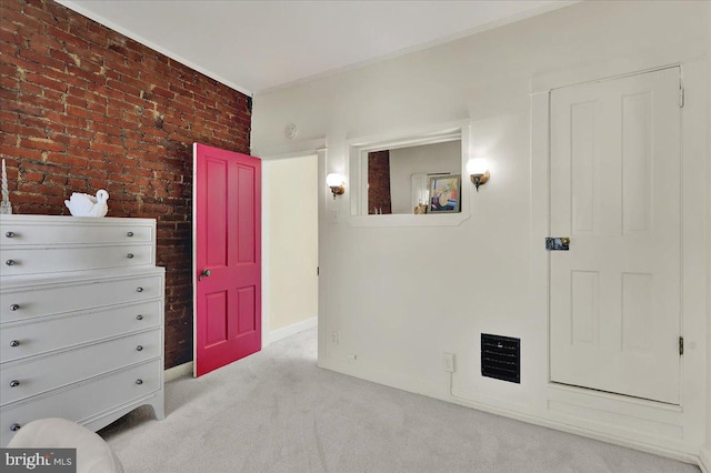 409 N Cherry St, Lancaster, PA 17602 - bedroom featuring light colored carpet, brick wall, and crown molding
